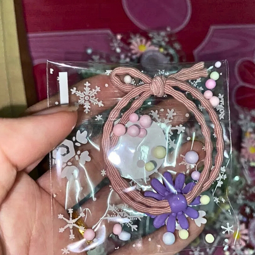 Souvenirs: Daisy hair bands packed in cute clear plastic bags with thank you stickers