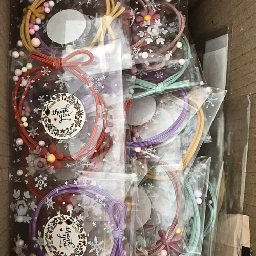 Souvenirs: Daisy hair bands packed in cute clear plastic bags with thank you stickers